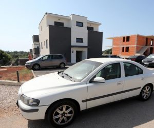 28.07.2021., Krk - Zgrada u ulici Mali Kartec u kojoj je suprug ubio suprugu. Stan u suterenu, ploicijska traka na vrartima i bijeli Volvo kojem je udubljen krov po kojem je lupao suprug ubojica.
Photo: Goran Kovacic/PIXSELL