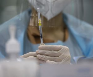 epa09341418 A Thai health official prepares a dose of AstraZenca COVID-19 vaccine at a vaccination center set up inside the Bang Sue Grand Station in Bangkok, Thailand, 13 July 2021. Thailand changed its vaccine policy allowing to mix China's Sinovac with the AstraZeneca vaccine in a bid to boost protection against the COVID-19 pandemic. Medical personnel will receive a third booster from a different vaccine after hundreds of medical workers were infected with COVID-19 despite being fully vaccinated with two doses of Sinovac. Thailand is seeing a rapid surge in the number of new COVID-19 cases and most recently, some workers at a Bangkok constructions camp have tested positive to what appears a 'hybrid strain' or 'mixed infection' of the Alpha and Delta COVID-19 variants.  EPA/NARONG SANGNAK