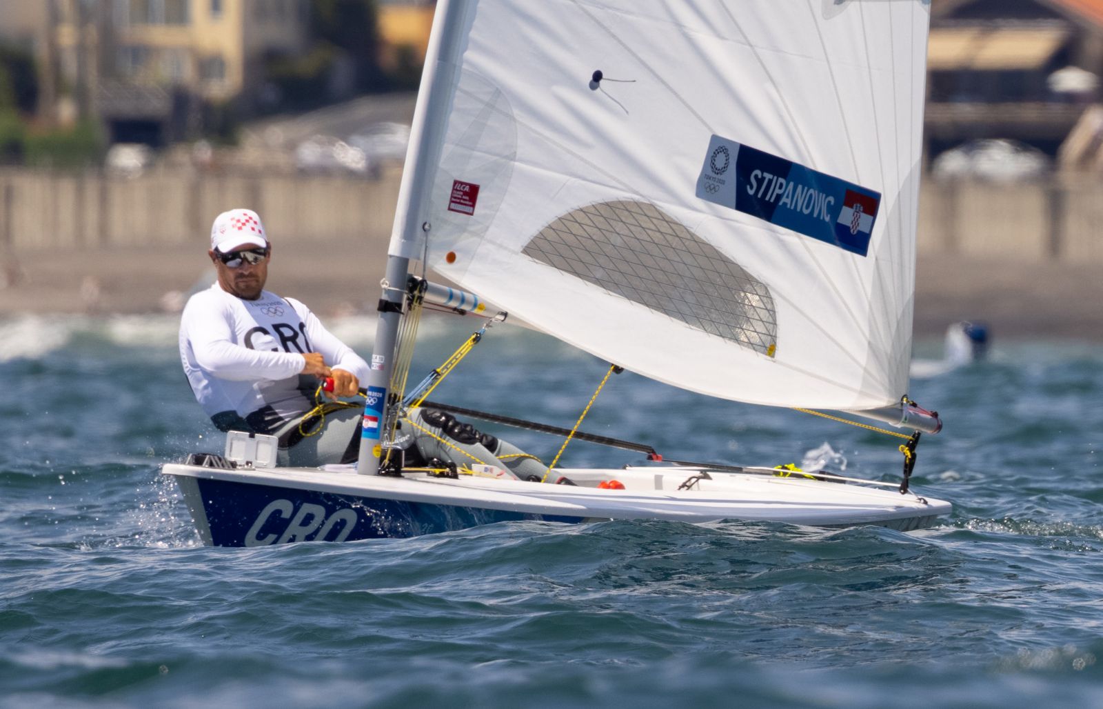 epa09361258 Sailors Tonci Stipanovic of Croatia (L) and Karl-Martin Rammo of Estonia (R) compete during a practice session of the Men's Laser discipline before the start of the the Sailing events of the Tokyo 2020 Olympic Games in Enoshima, Japan, 24 July 2021.  EPA/CJ GUNTHER