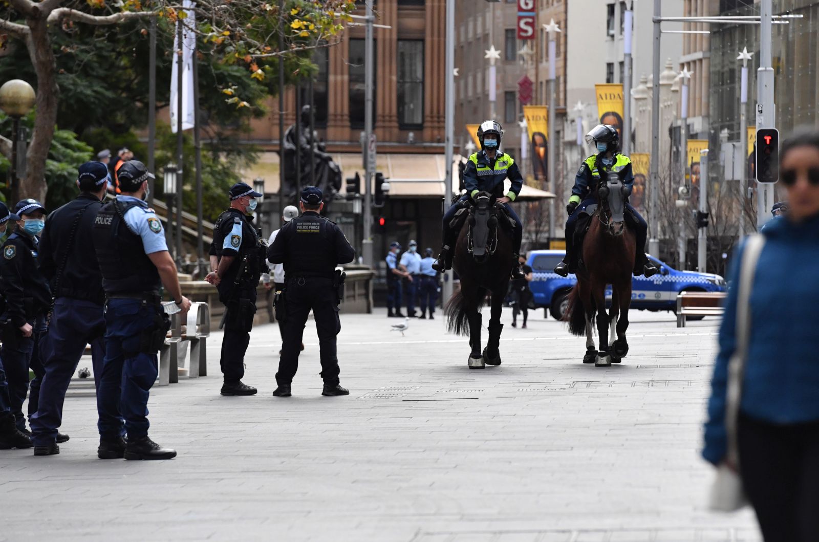 epa09380842 New South Wales police patrol George St in front of the Sydney Town Hall in anticipation of an anti-lockdown rally in Sydney, New South Wales, Australia, 31 July 2021.  EPA/MICK TSIKAS AUSTRALIA AND NEW ZEALAND OUT