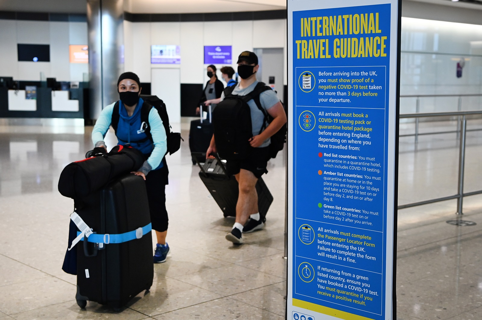 epa09382781 Passengers arrive at Heathrow Airport in London, Britain, 31 July 2021. Britain is set to open its borders to double jabbed US and EU citizens from 02 August, the UK government has announced.  EPA/ANDY RAIN