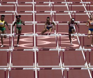 epa09386770 Jasmine Camacho-Quinn (C) of Puerto Rico on her way to win the gold medal in the women's 100-meter hurdles final at the 2020 Tokyo Summer Olympics in Tokyo, Japan, 02 August 2021.  EPA/PETER KLAUNZER EDITORIAL USE ONLY