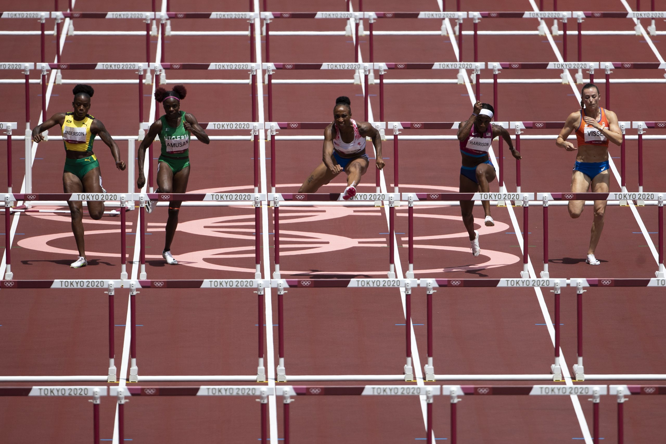 epa09386770 Jasmine Camacho-Quinn (C) of Puerto Rico on her way to win the gold medal in the women's 100-meter hurdles final at the 2020 Tokyo Summer Olympics in Tokyo, Japan, 02 August 2021.  EPA/PETER KLAUNZER EDITORIAL USE ONLY