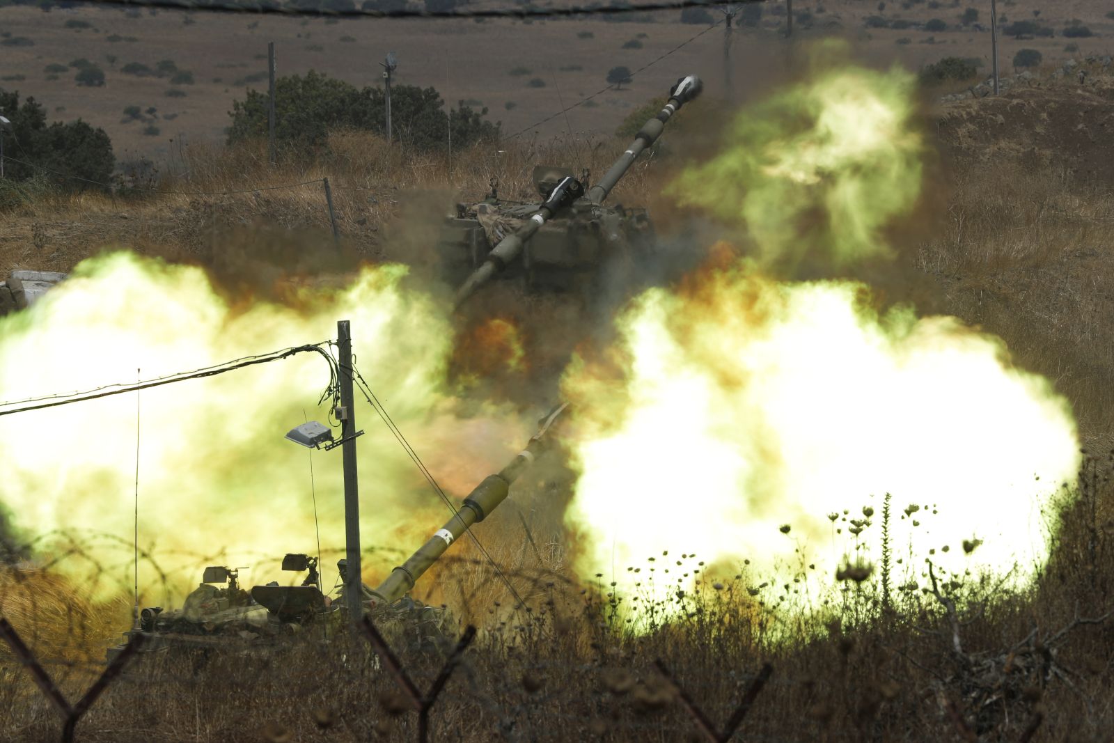 epa09400220 Israeli Artillery unit fires at targets in the Lebanese territory after rockets fired from the Lebanese side, 06 August 2021. At least ten rockets were fired from the Lebanese side of the border into Israel on 06 August and Israel responded with artillery fire. Israeli Army said most of the rockets were intercepted by the IDF Aerial Defense System while the rest of them landed in open areas adjacent to Har Dov.  EPA/ATEF SAFADI