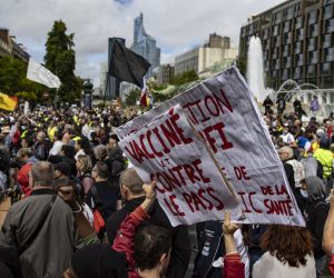 epa09404306 Protesters surrounded by anti-riot forces march during a demonstration against the COVID-19 health pass which grants vaccinated individuals greater ease of access to venues in France, in Paris, France, 07 August 2021. The national enforcement of the 'Health Pass' is expected to take effect on 09 August, after the French Constitutional Council has confirmed the government's law which extend the use of its Vaccinal Passeport (a QR code which proves the bearer has received full vaccination, or been tested negative for Covid in the last 72 hours) to cultural place, transport, and restaurants among other places.  EPA/IAN LANGSDON