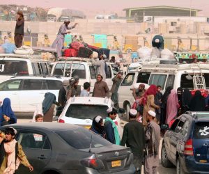 epa09415220 People arrive to go through checking as they prepare to cross into Afghanistan, at Chaman, Pakistan, 15 August 2021. Pakistani authorities reopened the border with Afghanistan on 13 August after several days of its closure. Taliban's shadow governor for Kandahar province had on 05 August issued a statement that announced the closing down of the border with Pakistan at Chaman, and said Islamabad should relax rules for crossing the frontier.  EPA/AKHTER GULFAM