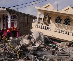 epa09423627 Mexican rescuers, from the Topos International Rescue Brigade, search for possible survivors of the 7.2 earthquake that occurred on 14 August, in Les Cayes, Haiti, 21 August 2021. The earthquake left some 2,200 dead and 12,000 wounded.  EPA/ORLANDO BARRIA