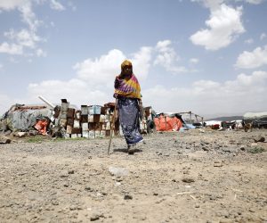 epa09428133 A displaced Yemeni woman walks through a camp for Internally Displaced Persons (IDPs) on the outskirts of Sana'a, Yemen, 24 August 2021. The United Nations has warned of alarming levels of humanitarian needs among four million internally displaced people in war-ravaged Yemen, who have been forced to build their own accommodation, using old blankets and plastic sheeting. Nearly 80 percent of the displaced are women and children. UNICEF estimated that nearly 21 million Yemenis of the 29 million-population, half of them are children, are in need of humanitarian aid for their day-to-day needs to survive. It warned that one child under the age of five dies every 10 minutes of preventable causes after more than six years of ongoing conflict and a Saudi-led bombing campaign.  EPA/YAHYA ARHAB