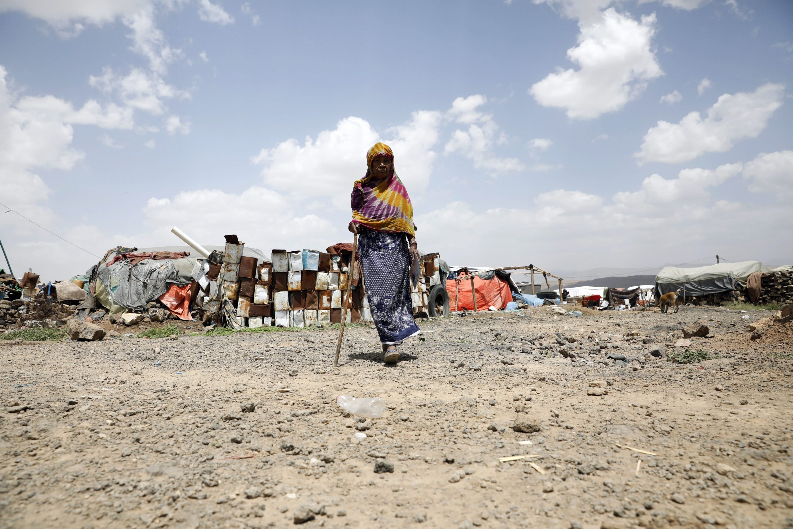 epa09428133 A displaced Yemeni woman walks through a camp for Internally Displaced Persons (IDPs) on the outskirts of Sana'a, Yemen, 24 August 2021. The United Nations has warned of alarming levels of humanitarian needs among four million internally displaced people in war-ravaged Yemen, who have been forced to build their own accommodation, using old blankets and plastic sheeting. Nearly 80 percent of the displaced are women and children. UNICEF estimated that nearly 21 million Yemenis of the 29 million-population, half of them are children, are in need of humanitarian aid for their day-to-day needs to survive. It warned that one child under the age of five dies every 10 minutes of preventable causes after more than six years of ongoing conflict and a Saudi-led bombing campaign.  EPA/YAHYA ARHAB