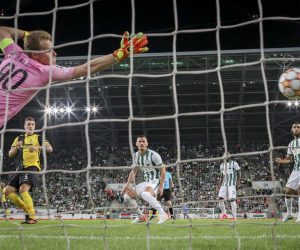 epa09428079 Young Boys' Cedric Zesiger, left, scores to 1-0 against Ferncvaros goalkeeper Denes Dibusz, during the UEFA Champions League Play-off second leg soccer match between Ferencvaros TC and BSC Young Boys of Switzerland at the Groupama Arena stadium in Budapest, Hungary, 24 August 2021.  EPA/THOMAS HODEL