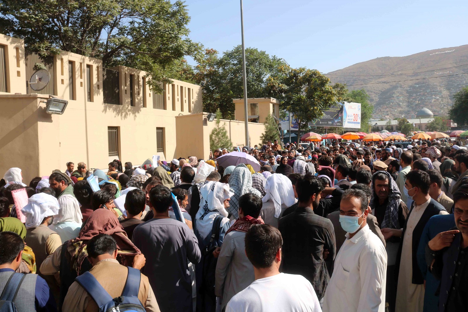 epa09428882 Afghans try to reach the airport after the Taliban announced they wouldn't allow access any longer, in Kabul, Afghanistan, 25 August 2021. Taliban spokesperson Zabiullah Mujahid said in a press conference on 24 August, that evacuation must be completed by August 31 and they will not allow Afghans to go to the airport from now on.  EPA/AKHTER GULFAM