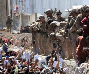 epa09430520 Afghans struggle to reach the foreign forces to show their credentials to flee the country outside the Hamid Karzai International Airport, in Kabul, Afghanistan, 26 August 2021. At least 13 people including children were killed in a blast outside the airport on 26 August. The blast occurred outside the Abbey Gate and follows recent security warnings of attacks ahead of the 31 August deadline for US troops withdrawal.  EPA/AKHTER GULFAM