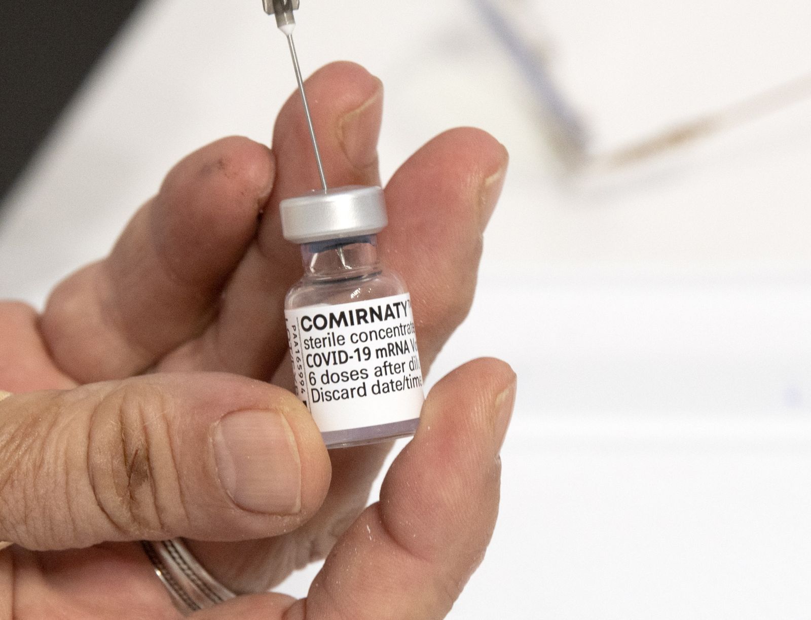 epa09432010 A nurse prepares a dose of the vaccine Pfizer-BioNtech against COVID-19 during the vaccination at the Arena 'Boris Trajkovski' in Skopje, Republic of North Macedonia, 27 August 2021. After a rapid increase in the number of newly infected with COVID-19, the Government adopted anti-covid measures against those who did not receive the vaccine. At the same time, the Macedonian government launched a campaign to convince its citizens that vaccination is the only way to stop the epidemic. North Macedonia is in the top ten in the world in terms of the number of deaths per one million from COVID-19.  EPA/GEORGI LICOVSKI