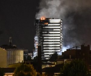 epa09436471 Smoke billows from the ‘Torre del Moro’ a 15-storey luxury building  that caught fire overnight, in Milan, Italy 30 August 2021.  EPA/Matteo Corner