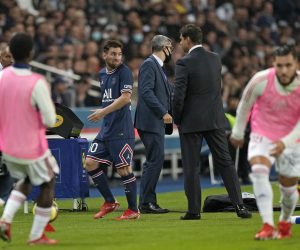 PSG's Lionel Messi looks at PSG's head coach Mauricio Pochettino after he was substituted during the French League One soccer match between Paris Saint-Germain and Lyon at the Parc des Princes in Paris Sunday, Sept. 19, 2021. (AP Photo/Francois Mori)