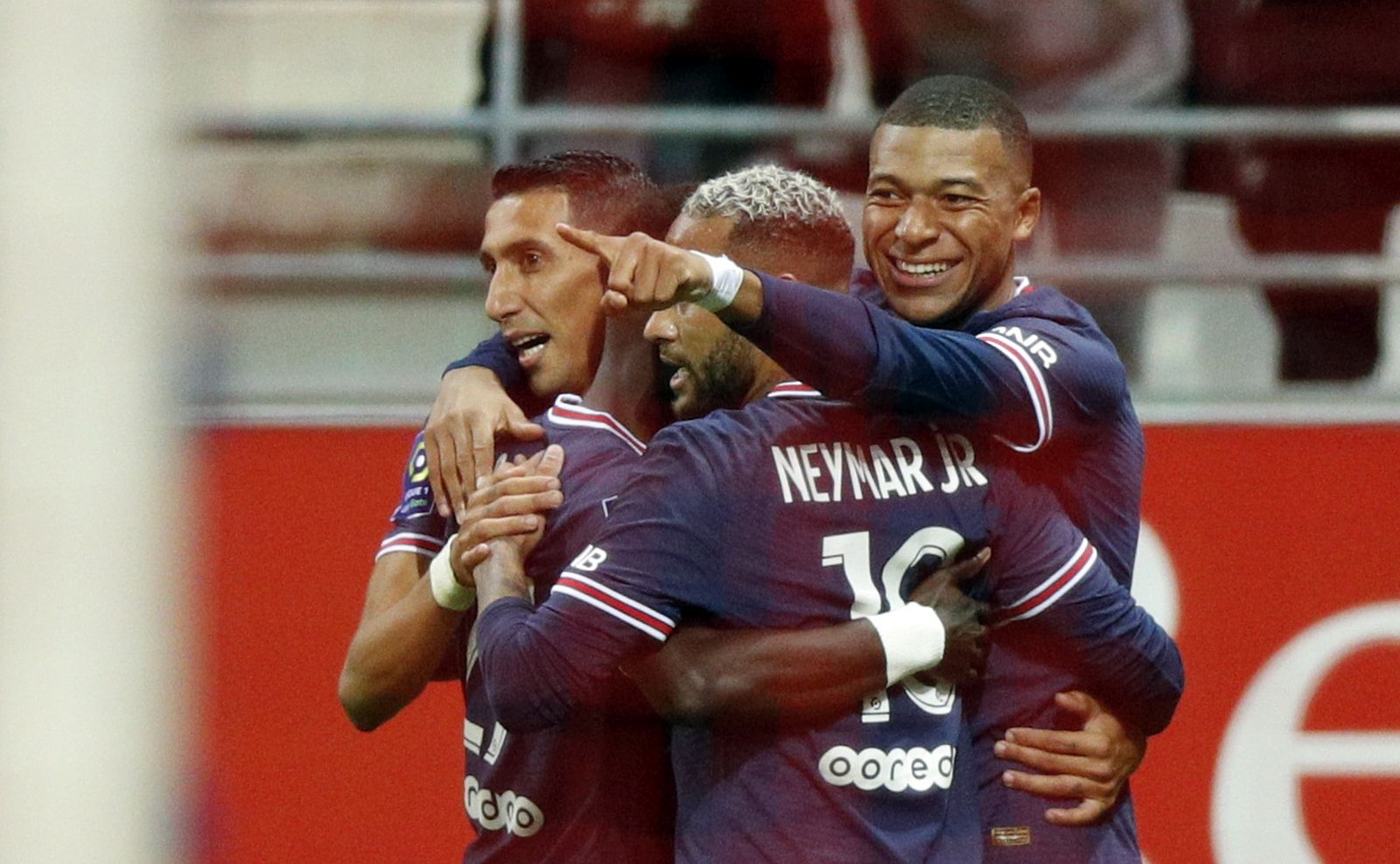 epa09436076 Paris Saint-Germain's Kylian Mbappe (R) celebrates with teammates after scoring the 2-0 lead during the French Ligue 1 soccer match between Stade Reims and Paris Saint-Germain (PSG) at Stade Auguste-Delaune II in Reims, France, 29 August 2021.  EPA/YOAN VALAT