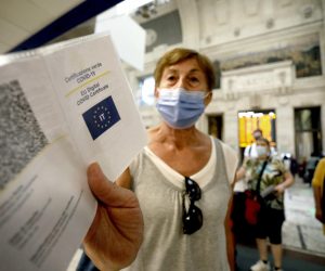 epa09440080 Green Pass vaccine passports of passengers departing from the Central Station are checked, in Milan, Italy, 01 September 2021. Starting from today Italy's Green Pass vaccine passport is obligatory for long-distance trains, domestic air flights and schools amid widespread misgivings.  EPA/Mourad Balti Touati