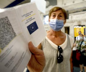 epa09440080 Green Pass vaccine passports of passengers departing from the Central Station are checked, in Milan, Italy, 01 September 2021. Starting from today Italy's Green Pass vaccine passport is obligatory for long-distance trains, domestic air flights and schools amid widespread misgivings.  EPA/Mourad Balti Touati