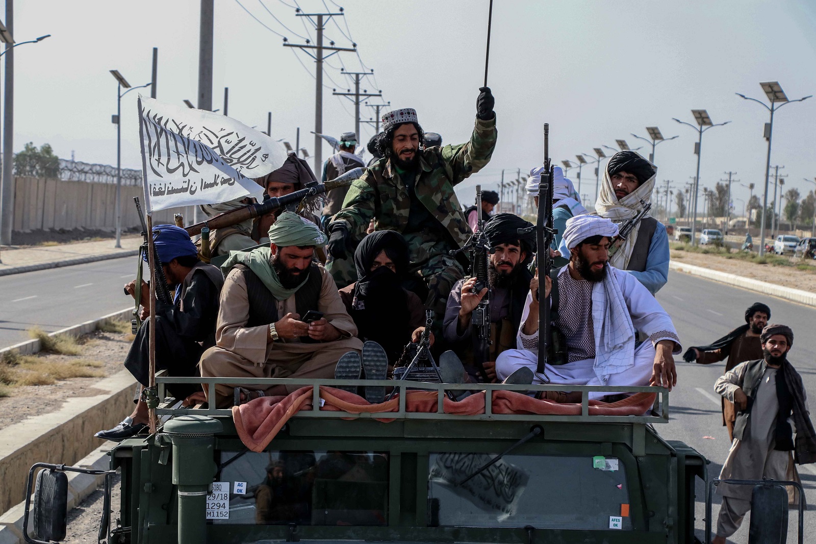 epa09440691 Taliban forces rally to celebrate the withdrawal of US forces in Kandahar, Afghanistan, 01 September 2021. The Taliban called for support from the international community to revive an economy battered by two decades of conflict and heavily dependent on foreign aid. chief Taliban spokesman Zabihullah Mujahid said one of the main objectives after the Taliban's 'victory' is the reconstruction of the country and assured that the international community must trust that the aid to Afghanistan under the Taliban will be directed through 'proper channels'.  EPA/STRINGER