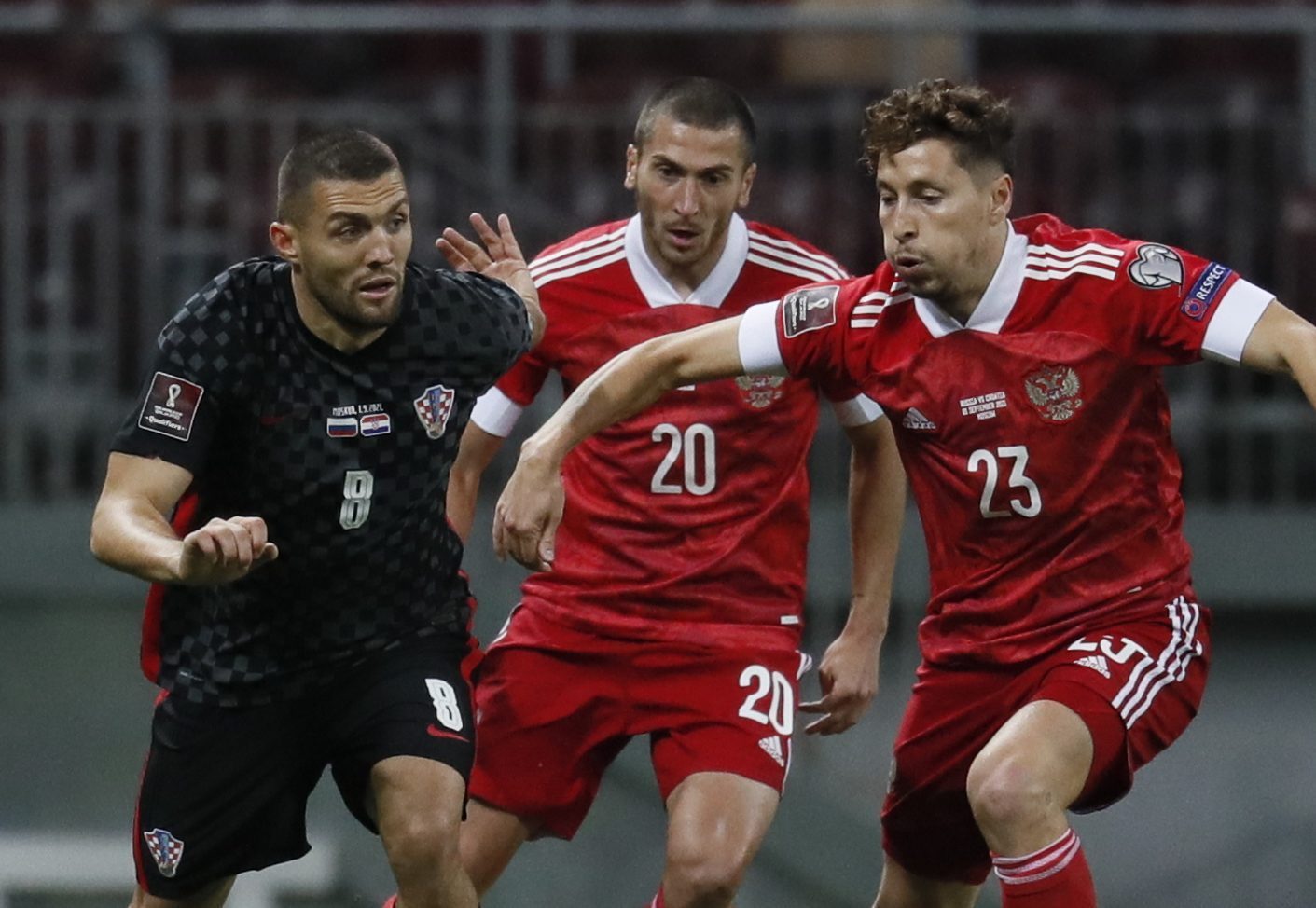 epa09441438 Mateo Kovacic (L) of Croatia in action against Aleksei Ionov  (C) and Daler Kuzyaev (R) of Russia during the FIFA World Cup 2022 Group H qualifying soccer match between Croatia and Russia in Moscow, Russia, 01 September 2021.  EPA/YURI KOCHETKOV