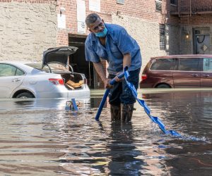 epa09444090 A man adjusts a water pump in a parking lot after the remnants of Hurricane Ida produced heavy rain and caused widespread flooding in New York City, New York, USA, 02 September 2021.  EPA/ANGEL COLMENARES