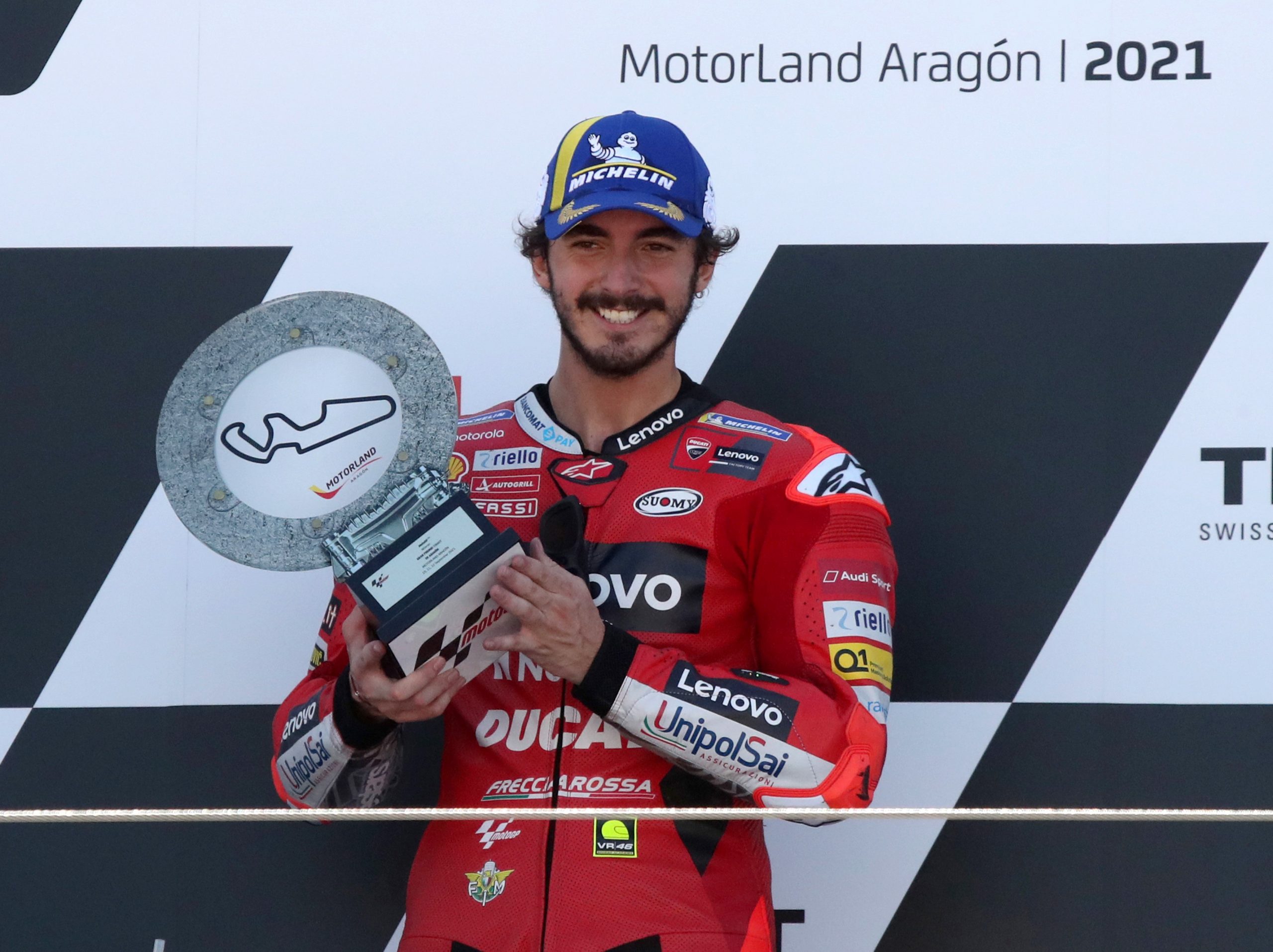 epa09463503 Winner Italian MotoGP rider Francesco Bagnaia of Ducati Lenovo Team celebrates on the podium after the Motorcycling Grand Prix of Aragon at MotorLand Aragon circuit in Alcaniz, Teruel, northern Spain, 12 September 2021.  EPA/JAVIER CEBOLLADA