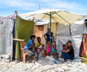 epa09468561 A family that lost their home in the earthquake a month ago lives in a makeshift home amid rubble and tents, in Les Cayes, Haiti, 14 September 2021. Thousands of people continue to live on the streets in inhumane conditions and tens of thousands of buildings remain in rubble in southern Haiti, as Haiti marks one month since the devastating earthquake of 14 August. At least 2,248 people died, 329 are still listed as missing and another 690,000 were affected by the earthquake, which caused damage to an extensive region along the entire southern peninsula of the country, where masses and floral offerings were celebrated today in memory of the victims.  EPA/Duples Plymouth
