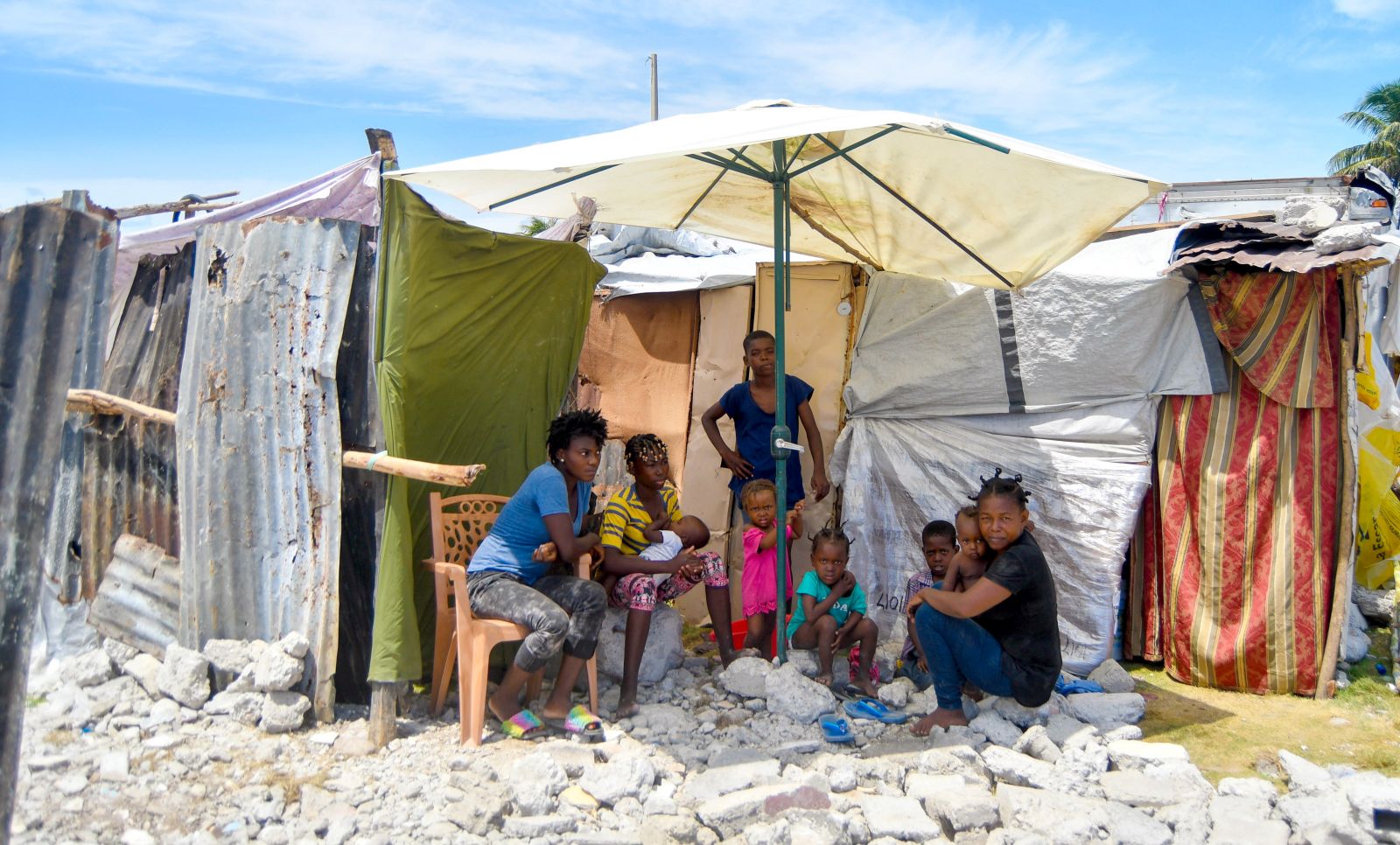 epa09468561 A family that lost their home in the earthquake a month ago lives in a makeshift home amid rubble and tents, in Les Cayes, Haiti, 14 September 2021. Thousands of people continue to live on the streets in inhumane conditions and tens of thousands of buildings remain in rubble in southern Haiti, as Haiti marks one month since the devastating earthquake of 14 August. At least 2,248 people died, 329 are still listed as missing and another 690,000 were affected by the earthquake, which caused damage to an extensive region along the entire southern peninsula of the country, where masses and floral offerings were celebrated today in memory of the victims.  EPA/Duples Plymouth