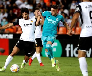 epa09477136 Valencia's striker Gonçalo Guedes (L) vies for the ball with Real Madrid's midfielder Federico Valverde (C) during the Spanish LaLiga soccer match between Valencia CF and Real Madrid held at Mestalla stadium in Valencia, eastern Spain, 19 September 2021.  EPA/Kai Forsterling