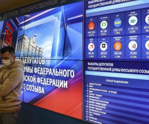 epa09477708 A man stands in front of screens displaying preliminary voting results in the Russian Central Election Commission following the Russian Parliamentary elections in Moscow, Russia, 20 September 2021. According to the preliminary information 195 representatives of United Russia, 15 representatives of the Communist Party, 7 representatives of A Just Russia, and 1 representative of the Liberal Democratic Party have won the State Duma (Russia's lower house of parliament) elections in single-member constituencies.  EPA/YURI KOCHETKOV