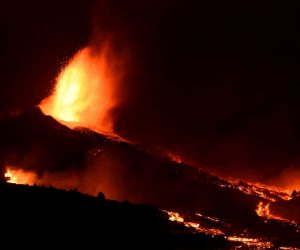 epa09478438 Lava rises up from the new volcano in Tacanade, La Palma, Canary islands, Spain, 20 September 2021.  The 'Cumbre Vieja' volcano began to erupt in Montana Rajada in the municipality of El Paso on 19 September. The area had registered hundreds of small earthquakes along the week as magma pressed the subsoil on its way out, urging the regional authorities to evacuate locals before the eruption took place.  EPA/MIGUEL CALERO