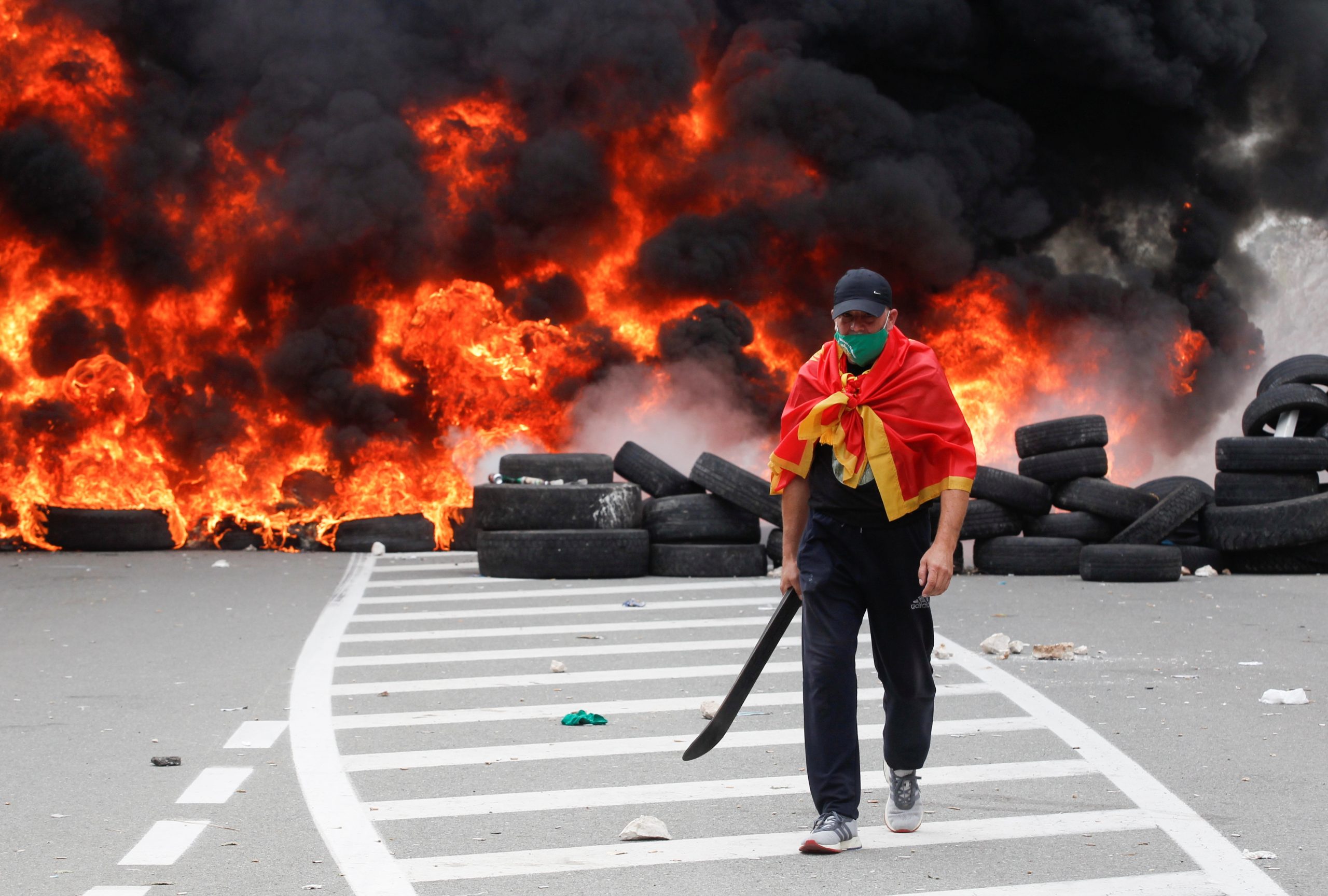 Protest against enthronement of Bishop Joanikije in Cetinje A demonstrator walks in front of a barricade set on fire during a protest against the enthronement of Bishop Joanikije in Cetinje, Montenegro, September 5, 2021. REUTERS/Stevo Vasiljevic STEVO VASILJEVIC