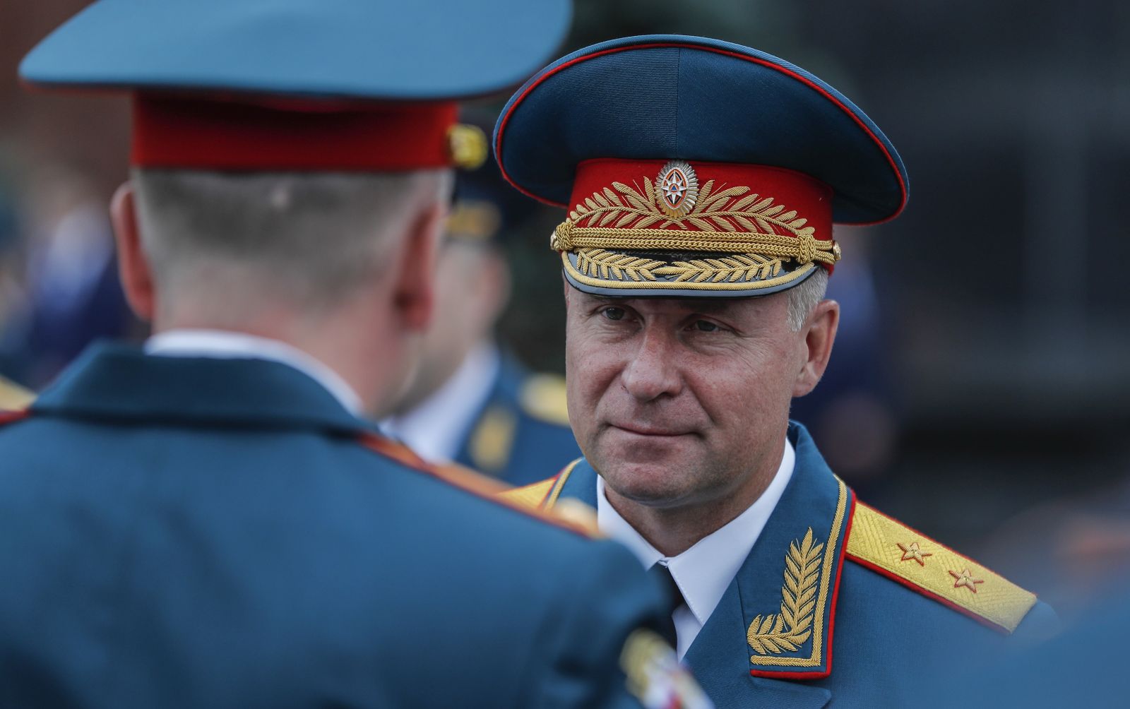 epa09454914 (FILE) The newly appointed Minister of the Russian Federation for Civil Defense, Emergency Situations and Elimination of Consequences of Natural Disasters Ministry, Yevgeny Zinichev (R), attending a graduation ceremony of students and cadets of the Russian Emergencies Ministry institutions in the Red Square in Moscow, Russia, 21 July 2018 ( re-issued 08 September 2021). Russian Emergencies Minister Yevgeny Zinichev tragically died 08 September 2021 in Norilsk while saving a man's life during an inter-departmental exercise to protect the Arctic zone of Russia frrom emergency situations.  EPA/SERGEI ILNITSKY / POOL