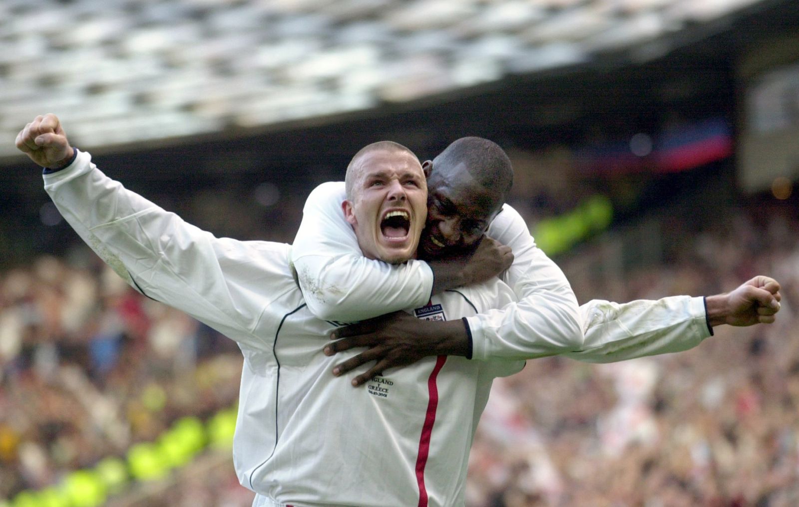 FILE - This is a Saturday, Oct. 6, 2001 file photo of England's captain David Beckham, left, as he  is congratulated by teammate Emile Heskey after scoring their second goal against Greece during their 2002 World Cup qualifying match at Old Trafford Manchester England.  England soccer team coach Fabio Capello said Wednesday Aug. 11, 2010  that  Davis Beckham the 35-year-old former captain, who has made 115 appearances for his country and played in three World Cups, is too old and will no longer be a part of his plans as he prepares for the 2012 European Championship qualifying campaign.  (AP Photo/Adam Butler, File)