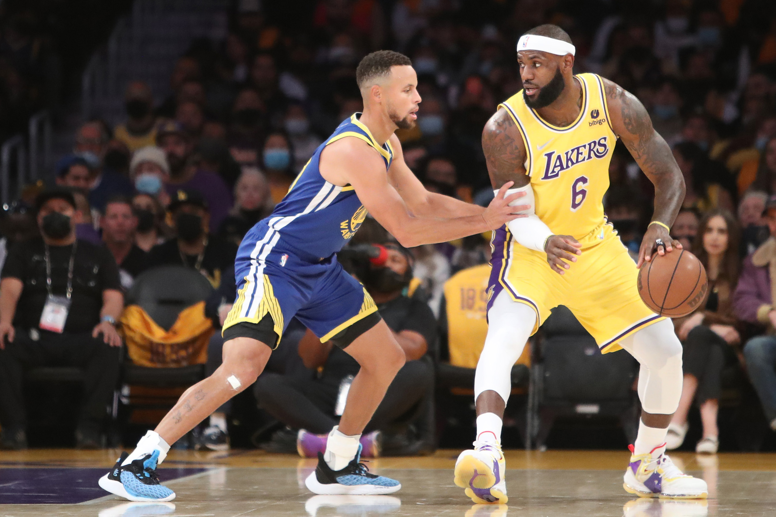 Oct 19, 2021; Los Angeles, California, USA; Los Angeles Lakers forward LeBron James (6) dribbles a ball against Golden State Warriors guard Stephen Curry (30) during the first quarter at Staples Center. Mandatory Credit: Kiyoshi Mio-USA TODAY Sports