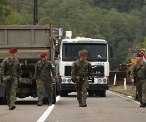 epa09492596 NATO peacekeepers patrol the area near the border crossing between Kosovo and Serbia in Jarinje, Kosovo, 28 September 2021. Kosovo Serbs in the northern part of the ethnically divided town of Mitrovica set up road barricades with trucks and cars to protest against the Kosovo government’s entry ban on vehicles with Serbian registration plates.  EPA/VALDRIN XHEMAJ