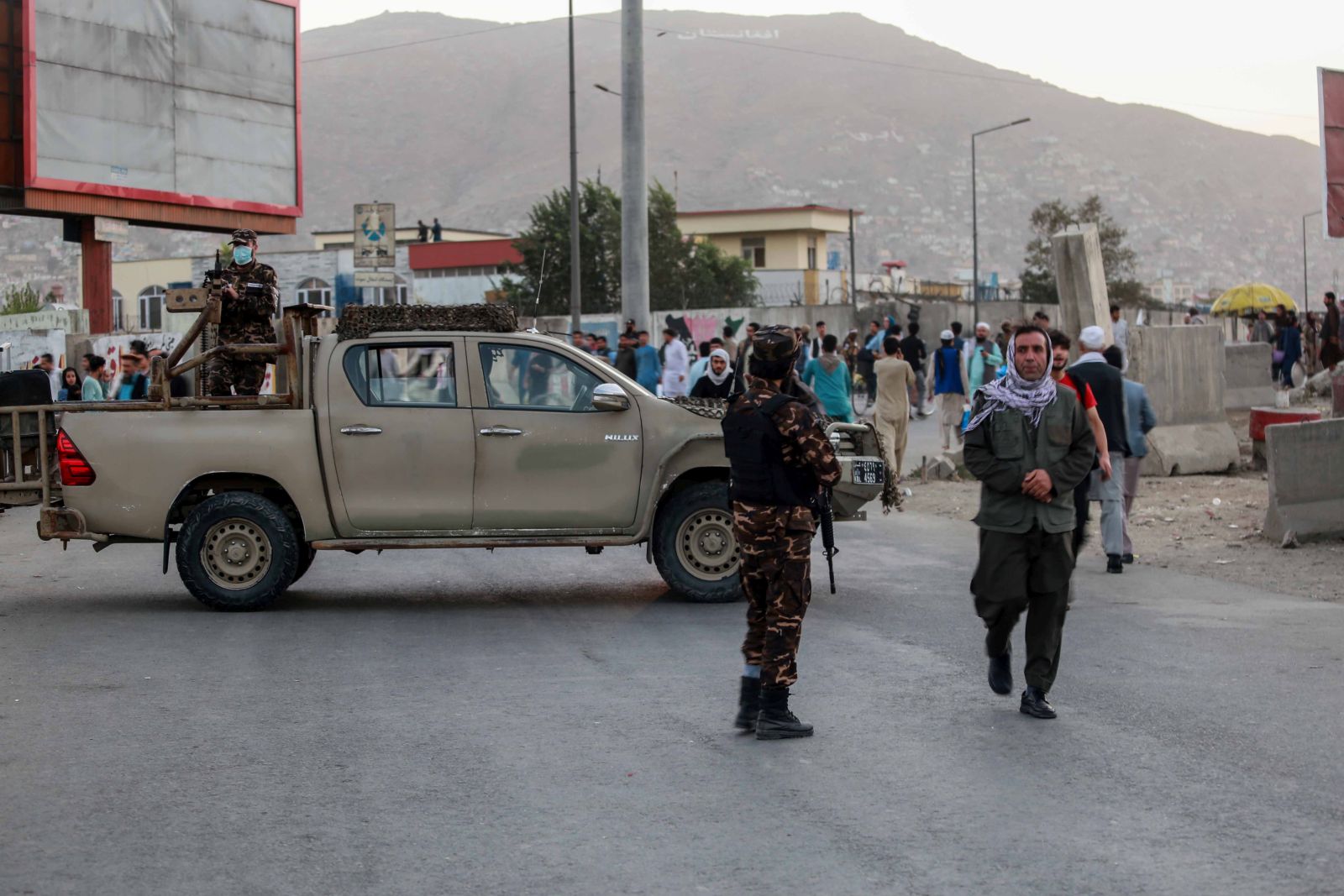 epa09503724 Taliban stand guard near the scene of a bomb blast in Kabul, Afghanistan, 03 October 2021. At least two people were killed when a bomb exploded outside the Eid Gah Mosque in Kabul where a memorial service was being held for the mother of Taliban spokesman Zabihullah Mujahid.  EPA/STRINGER