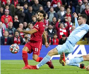epa09504095 Mohamed Salah (L) of Liverpool scores the 2-1 lead during the English Premier League soccer match between Liverpool FC and Manchester City in Liverpool, Britain, 03 October 2021.  EPA/Andrew Yates EDITORIAL USE ONLY. No use with unauthorized audio, video, data, fixture lists, club/league logos or 'live' services. Online in-match use limited to 120 images, no video emulation. No use in betting, games or single club/league/player publications