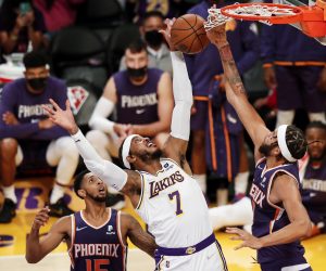 epa09517916 Los Angeles Lakers forward Carmelo Anthony (C) and Phoenix Suns center JaVale McGee (R) jump up for a rebound during the first quarter of the pre-season NBA basketball game between at the Phoenix Suns and the Los Angeles Lakers at the Staples Center in Los Angeles, California, USA, 10 October 2021.  EPA/CAROLINE BREHMAN  SHUTTERSTOCK OUT