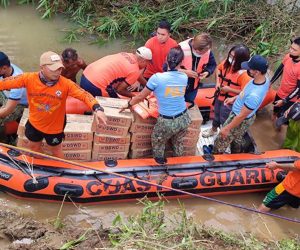 epa09519876 A handout photo made available by the Philippine Coast Guard (PCG) shows coastguard personnel on a rubber boat conducting a rescue operation at a flooded village in the town of Santa Teresita, Cagayan province, Philippines, 12 October 2021. According to the government agency National Disaster Risk Reduction and Management Council (NDRRMC), eleven people have died and seven other are missing after Typhoon Kompasu hit the country's northern island of Luzon.  EPA/PHILIPPINE COAST GUARD HANDOUT -- BEST QUALITY AVAILABLE -- HANDOUT EDITORIAL USE ONLY/NO SALES