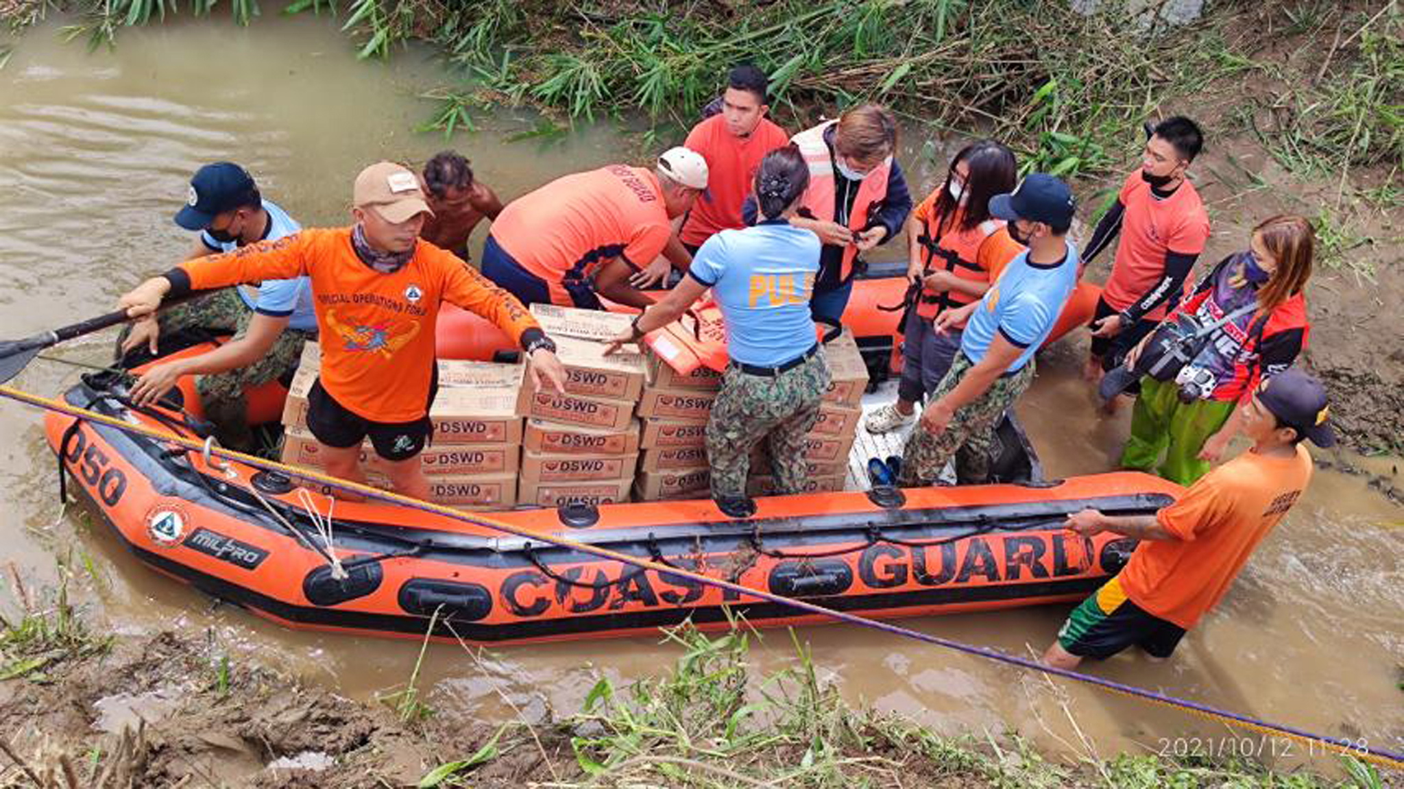 epa09519876 A handout photo made available by the Philippine Coast Guard (PCG) shows coastguard personnel on a rubber boat conducting a rescue operation at a flooded village in the town of Santa Teresita, Cagayan province, Philippines, 12 October 2021. According to the government agency National Disaster Risk Reduction and Management Council (NDRRMC), eleven people have died and seven other are missing after Typhoon Kompasu hit the country's northern island of Luzon.  EPA/PHILIPPINE COAST GUARD HANDOUT -- BEST QUALITY AVAILABLE -- HANDOUT EDITORIAL USE ONLY/NO SALES