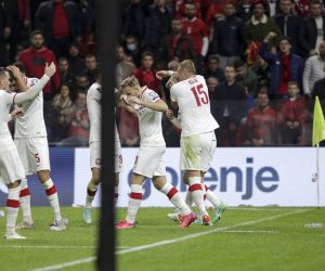 epa09521030 Players of Poland cover their heads as spectators throw bottles during the FIFA World Cup 2022 qualifying soccer match between Albania and Poland in Tirana, Albania, 12 October 2021.  EPA/Malton Dibra