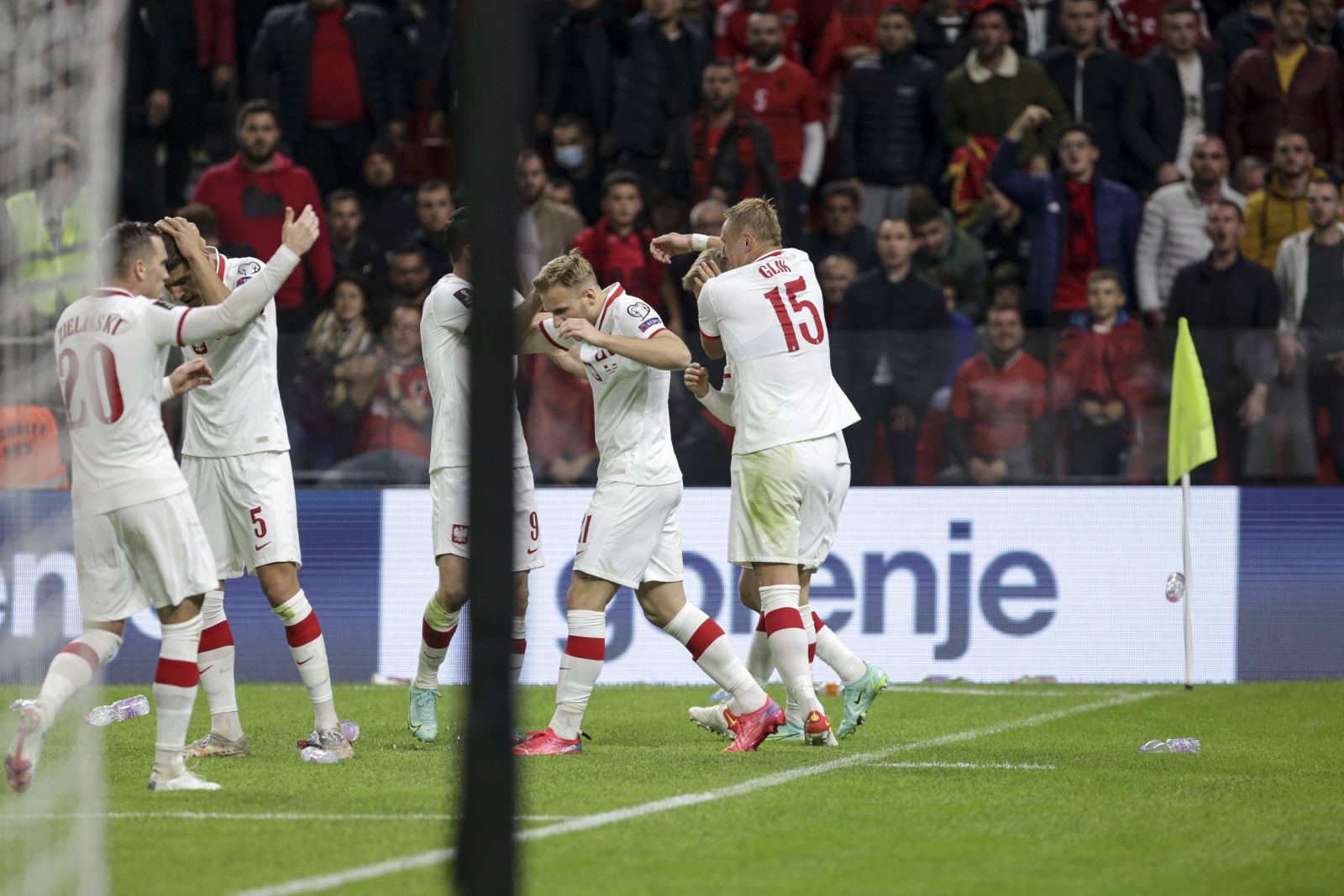 epa09521030 Players of Poland cover their heads as spectators throw bottles during the FIFA World Cup 2022 qualifying soccer match between Albania and Poland in Tirana, Albania, 12 October 2021.  EPA/Malton Dibra