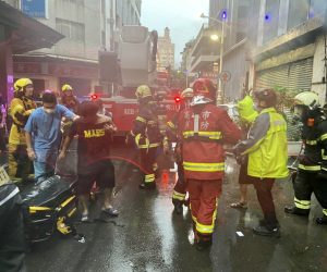 epa09522838 A handout photo made available by Kaohsiung fire bureau shows firefighters and rescuers assisting survivors after a fire on a commercial and residential building in Kaohsiung city, southern Taiwan, 14 October 2021. At least seven persons are dead and several injured after the commercial and residential building fire.  EPA/KAOHSIUNG FIRE BUREAU HANDOUT  HANDOUT EDITORIAL USE ONLY/NO SALES
