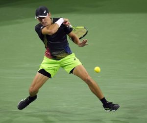 epa09522747 Alex De Minaur of Australia hits a return in his match against Stefanos Tsitsipas of Greece at the BNP Paribas Open tennis tournament at the Indian Wells Tennis Garden in Indian Wells, California, USA, 13 October 2021.  EPA/RAY ACEVEDO