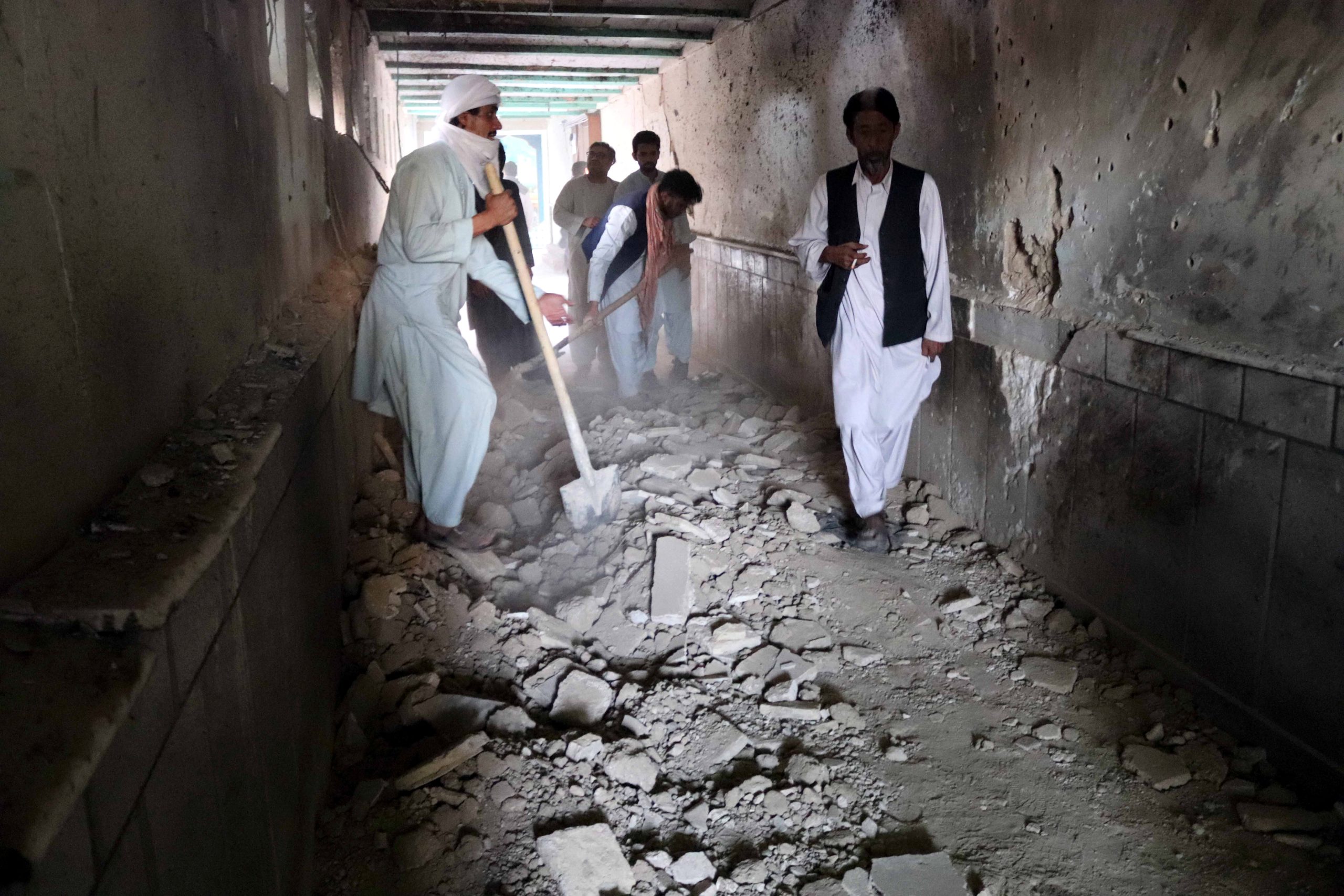 epa09525446 People inspect the scene of a bomb blasts during Friday congregational prayers at Shi'ite Muslims Mosque in Kandahar, Afghanistan, 15 October 2021. At least 32 worshipers died, and many others suffered injuries in a powerful explosion that ripped through a Shia mosque in the southern Afghan city of Kandahar during Friday prayers, officials said. The Islamic State has carried out numerous attacks, in recent years, against the Shia minority, especially the Hazaras. The Taliban have launched massive operations against the Islamic State in different Afghan provinces, aiming to finish a group that they consider the main threat to their government.  EPA/STRINGER