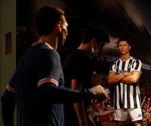 epa09530000 Visitors walk past the wax figures of Portuguese national soccer player Cristiano Ronaldo (R) and Argentina's Lionel Messi (L) at the Madame Tussauds wax museum in Gulf emirate of Dubai, United Arab Emirates on 18 October 2021. The newly opened Madame Tussauds Dubai features 60 wax figures of personalities from the fields of sports, music, film and politics.  EPA/ALI HAIDER