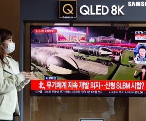 epa09531365 A woman stands near a TV screen showing a news program reporting on North Korea's latest missile launch with file footage at a station in Seoul, South Korea, 19 October 2021. According to South Korea's Joint Chiefs of Staff (JCS), North Korea fired an unidentified projectile toward the East Sea on 19 October.  EPA/JEON HEON-KYUN