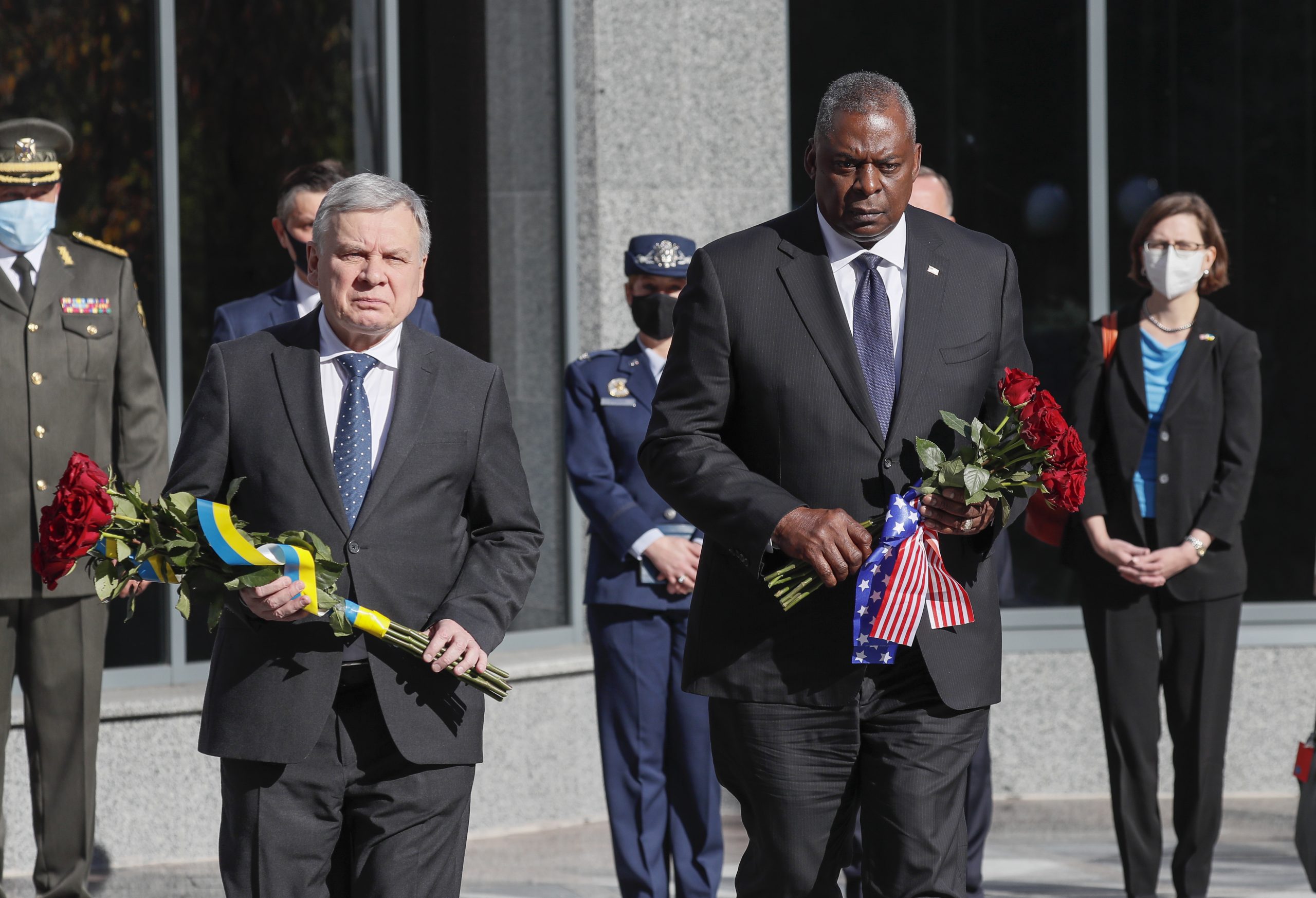 epa09531574 U.S. Defense Secretary Lloyd Austin (R) and Ukrainian Defence Minister Andriy Taran (L) visit a pantheon commemorating fallen defenders of Ukraine prior to their meeting in Kyiv, Ukraine, 19 October 2021.  EPA/GLEB GARANICH / POOL