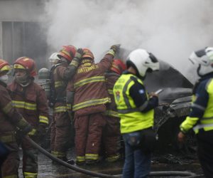 epa09533279 Police and firefighters at the scene where vehicles were burnt at Congress headquarters after a protest by retired military in Guatemala City, Guatemala, 19 October 2021. Guatemalan National Civil Police evacuated deputies and workers from Congress during a violent protest by retired soldiers, who forcibly entered the parliamentary building and burned vehicles and some of its offices.  EPA/ESTEBAN BIBA